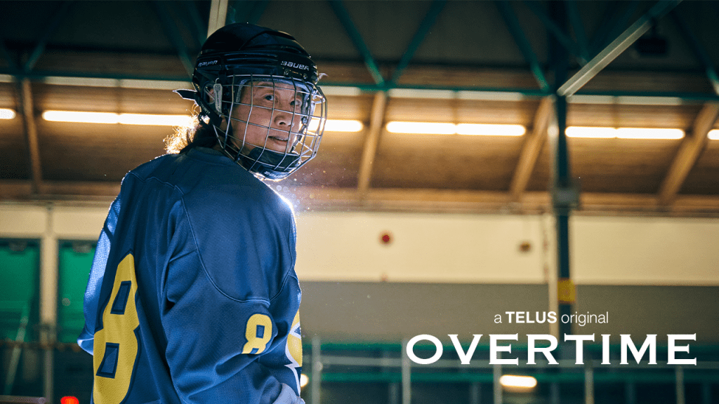 A Chinese woman in full hockey gear is backlit looking at the camera. She is wearing number 8. In the bottom right corner text reads "Overtime: a Telus original."